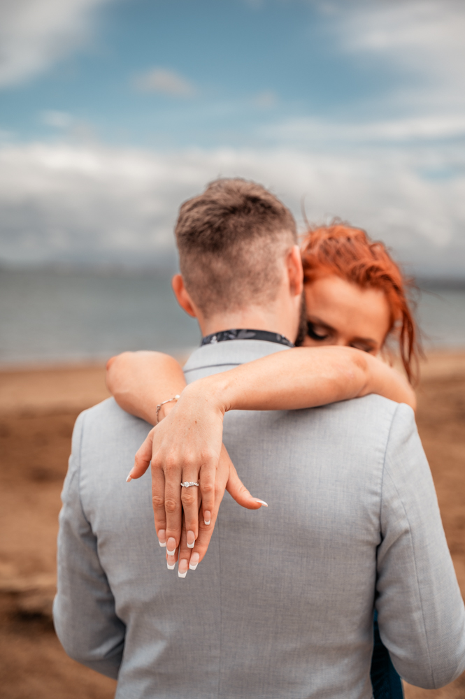 bride to be with arms draped over fiancé's shoulders to show off engagement ring- engagement photography by Jamie Simmons