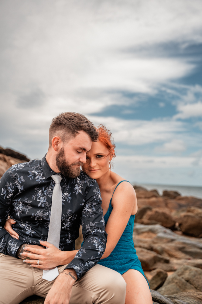 man and woman embracing lovingly at a townsville beach - engagement photography by Jamie Simmons