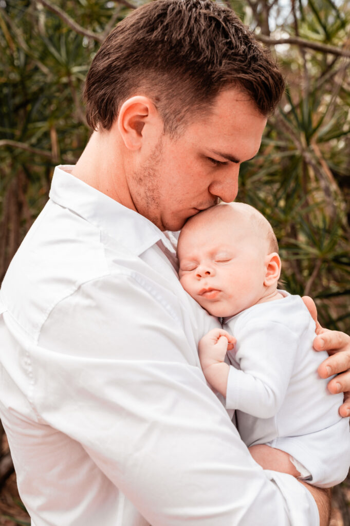 newborn baby outdoor cuddles with dad - newborn photography by Jamie Simmons
